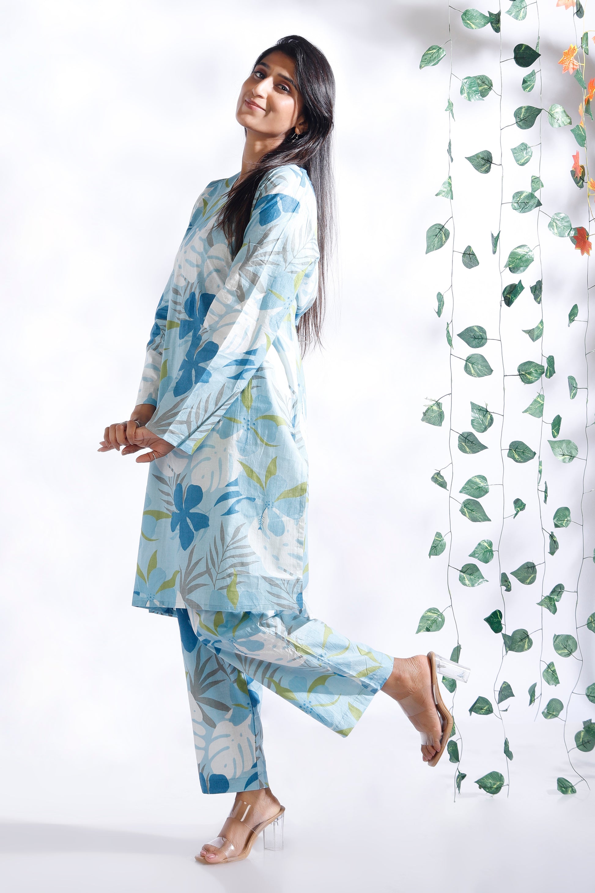 Woman wearing a floral outfit with a white background