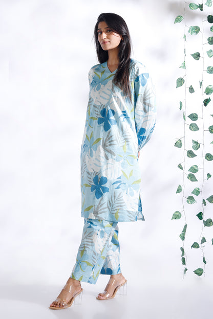 Woman wearing a floral outfit with a white background