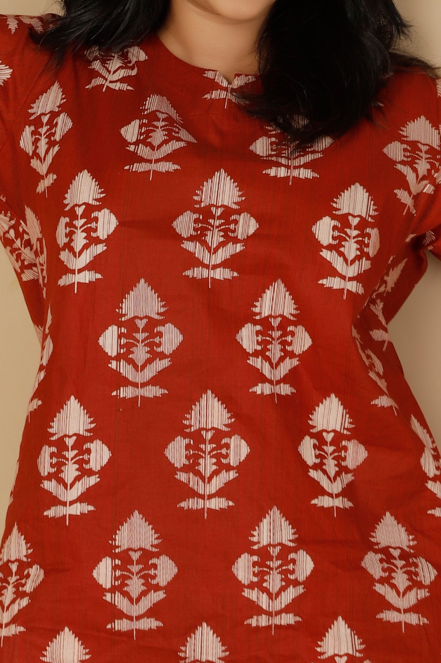 Red garment with white floral pattern worn by a person