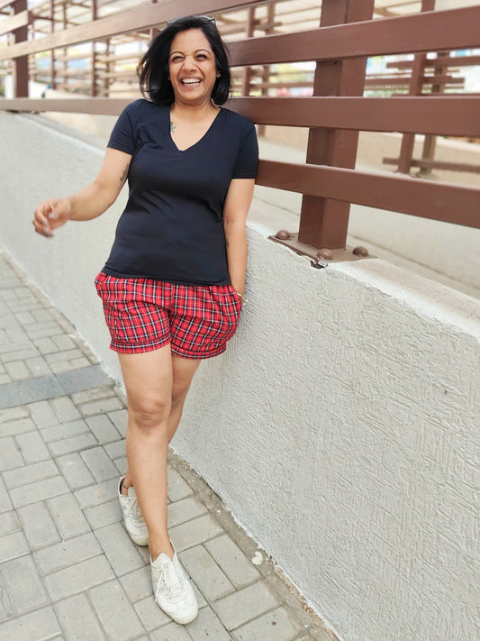 Girl in red shorts laughing, showcasing the comfort and casual style of our BREATHABLES® cotton loungewear.